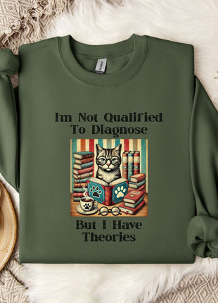 a green sweatshirt with a humorous text and an illustration of a cat surrounded by books.