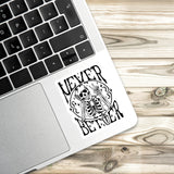 a sticker with a skeleton and the text "NEVER BETTER" on a laptop keyboard.