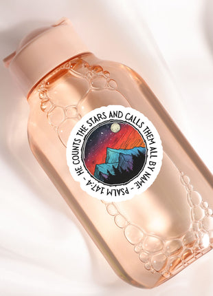 a bottle with a sticker on it sitting on a white surface