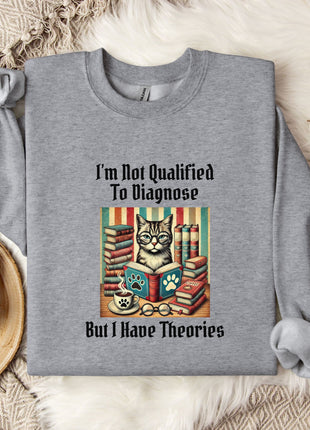 a gray sweatshirt with a printed design of a cat surrounded by books and a cup of coffee, along with the text "I'm Not Qualified To Diagnose But I Have Theories".