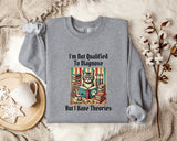 a gray sweatshirt with a printed design of a cat surrounded by books and a cup of coffee, along with the text "I'm Not Qualified To Diagnose But I Have Theories".