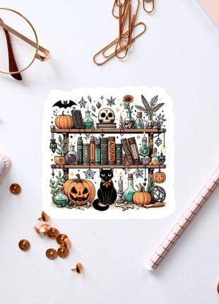 a sticker of a book shelf with a cat and pumpkins