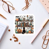 a sticker of a book shelf with a cat and pumpkins