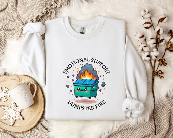 a white sweatshirt with a graphic design depicting a fire-breathing dumpster, accompanied by the text 