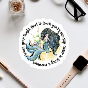 a sticker with a picture of a mermaid on it