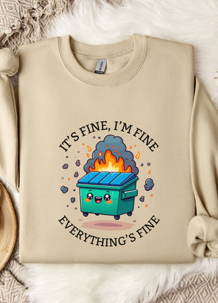 a beige sweatshirt with a graphic design depicting a trash can with flames coming out of it, accompanied by the text "It's fine, I'm fine Everything's fine".