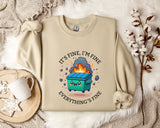 a beige sweatshirt with a graphic design depicting a trash can with flames coming out of it, accompanied by the text "It's fine, I'm fine Everything's fine".