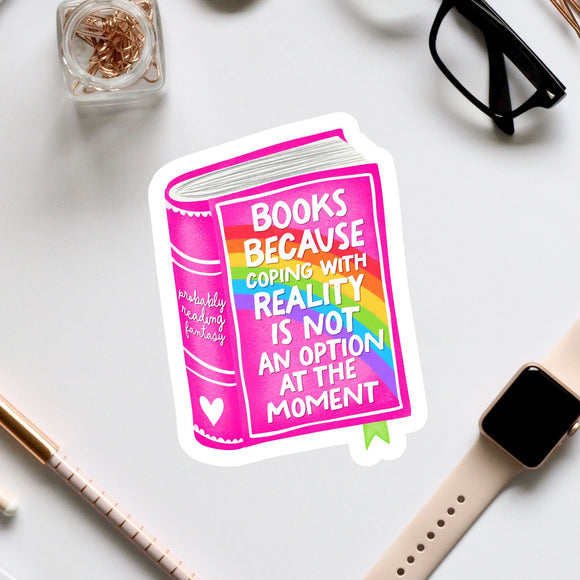 a sticker with a book and a quote about coping with reality, surrounded by various office supplies and a pair of glasses.
