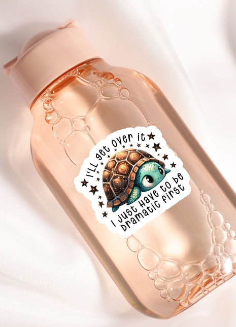 A pink bottle with a sticker featuring a cartoon turtle and the text "I'll see over it, I just have to be dramatic first".