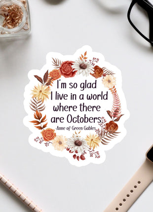 a sticker with a quote from the book "Anne of Green Gables" surrounded by a wreath of autumn flowers and leaves.