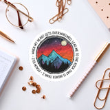a sticker with a picture of a mountain and stars on it