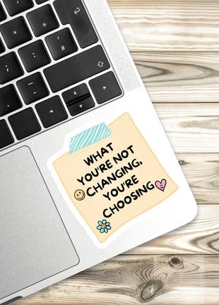 a sticker with a message on a laptop keyboard.