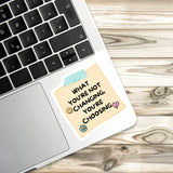 a sticker with a message on a laptop keyboard.