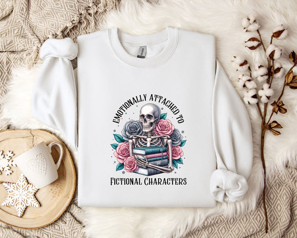 a white sweatshirt with a graphic design of a skeleton holding a book and flowers, surrounded by the text 