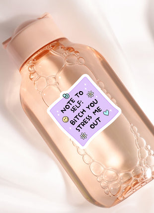 A pink bottle with a label that says "NOT TO YOU: BITCH YOU STRESS ME OUT"