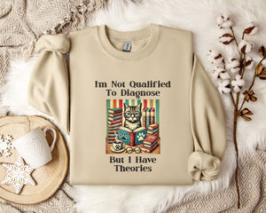 a beige sweatshirt with a humorous text and an illustration of a cat surrounded by books, placed on a bed with a white blanket and a mug.