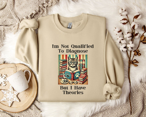 a beige sweatshirt with a humorous text and an illustration of a cat surrounded by books, placed on a bed with a white blanket and a mug.