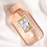 A pink bottle with a label featuring a cartoon illustration of a sand timer with a skull and crossbones.