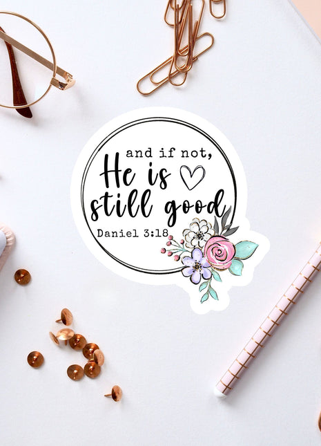 a white background with various office supplies and a sticker with a quote.