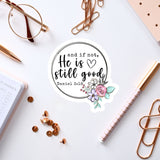 a white background with various office supplies and a sticker with a quote.